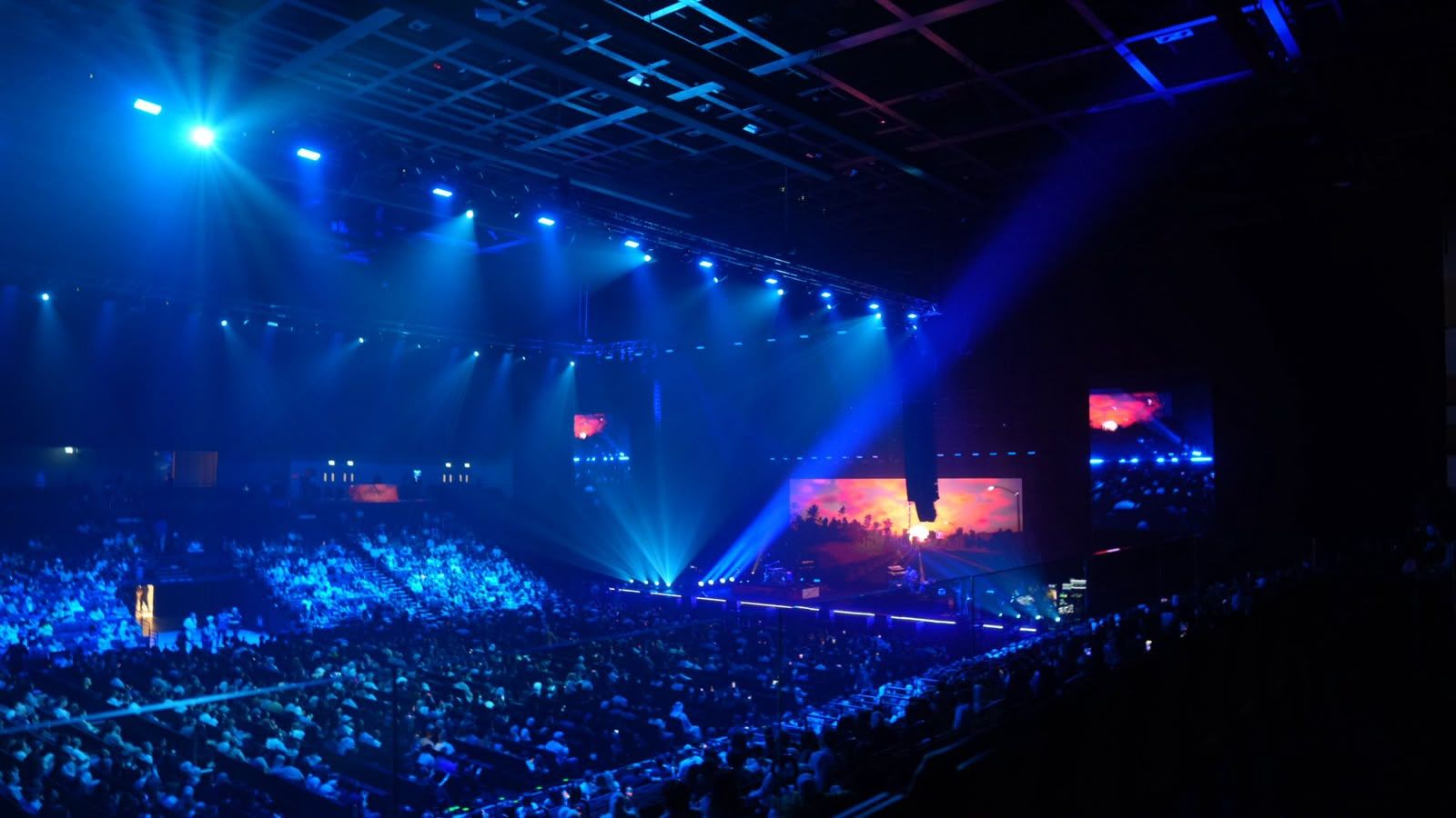 Arena audience in blue stage light