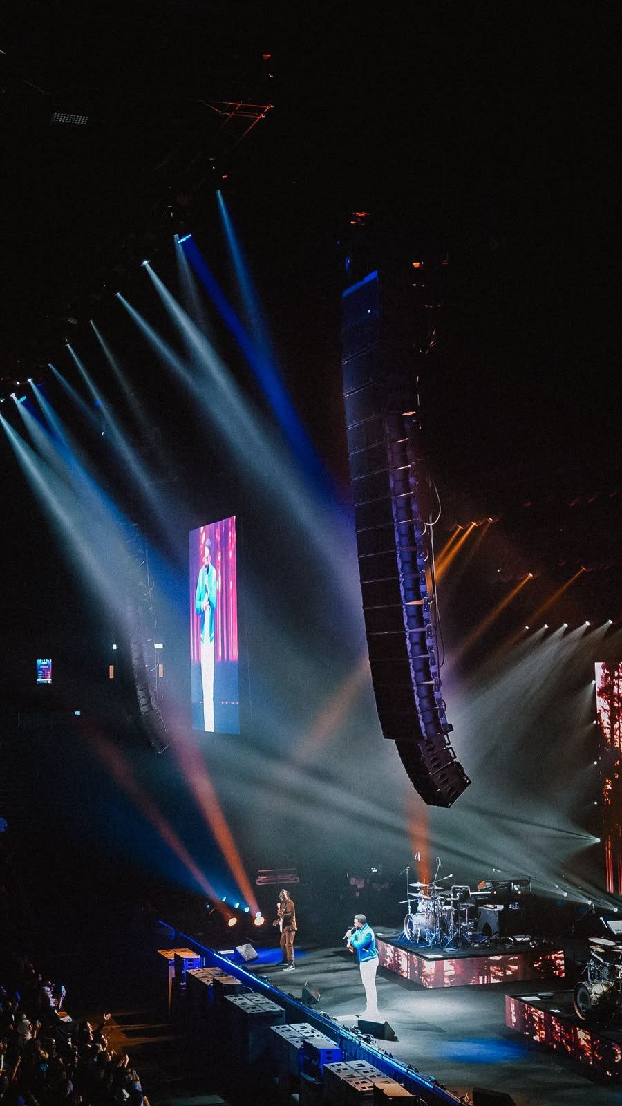Flown line array beside the stage during an arena show