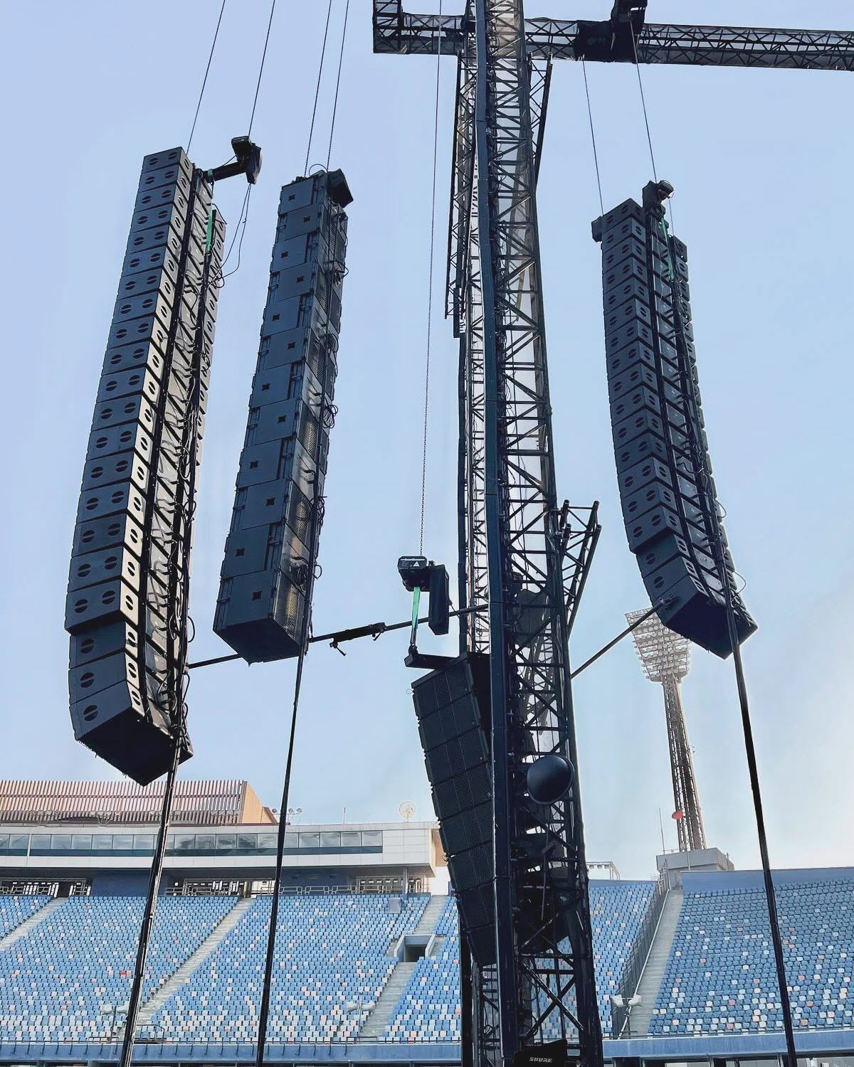 Main and side line arrays flown from towers at a stadium